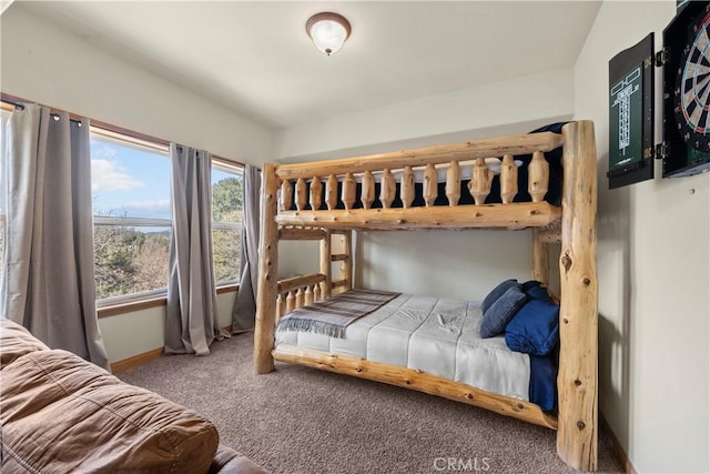 bedroom featuring carpet and baseboards