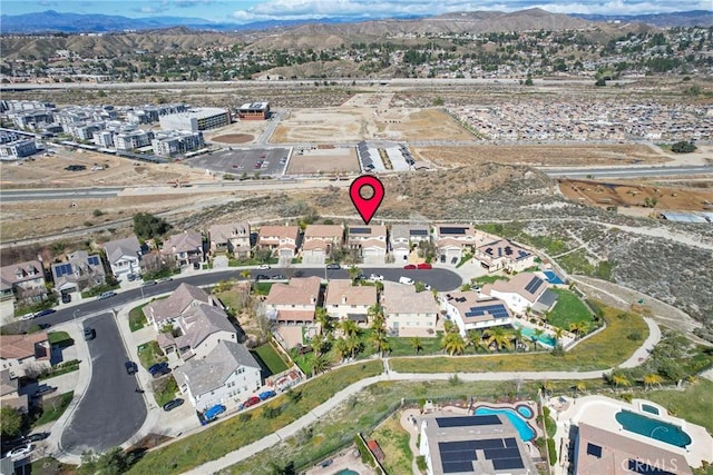 drone / aerial view featuring a residential view and a mountain view