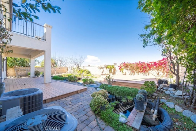 view of patio / terrace featuring a deck, central AC, and a fenced backyard