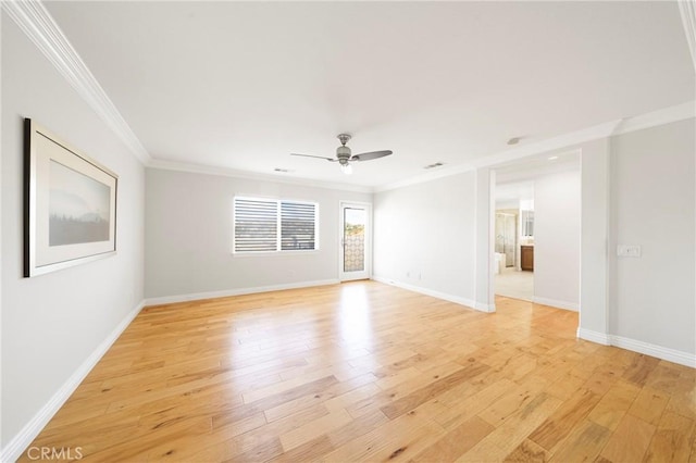 spare room featuring a ceiling fan, light wood-style flooring, baseboards, and crown molding