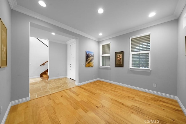 empty room with light wood finished floors, ornamental molding, and recessed lighting