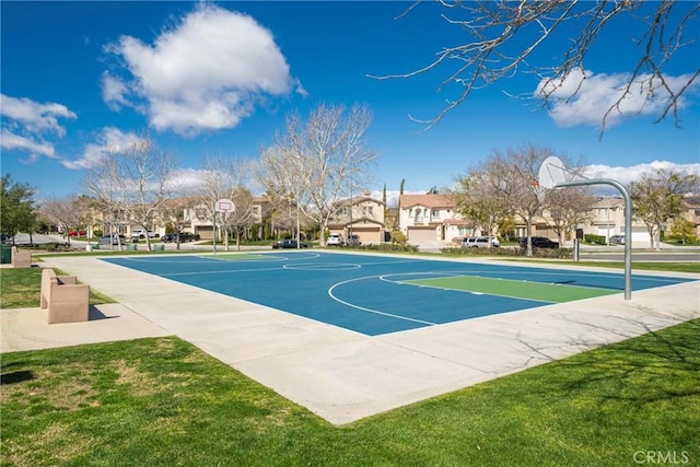view of sport court featuring community basketball court, a yard, and a residential view
