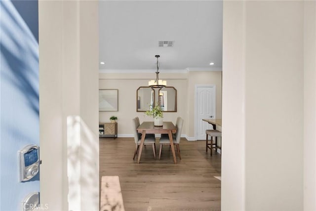 dining room featuring recessed lighting, visible vents, ornamental molding, wood finished floors, and baseboards