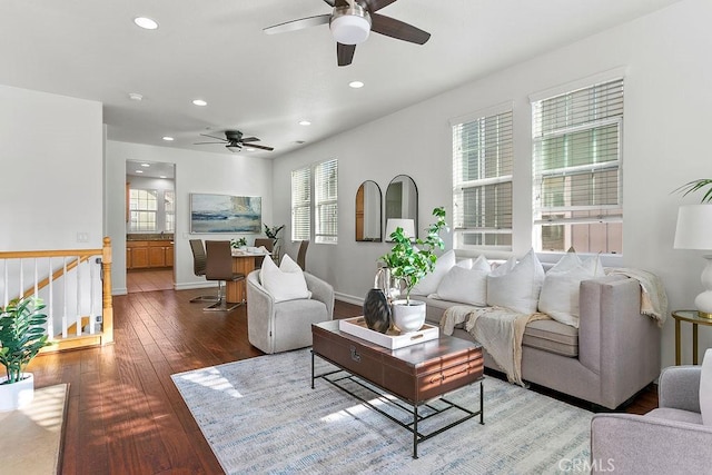 living room featuring recessed lighting, baseboards, and hardwood / wood-style floors