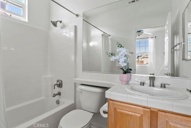 full bath featuring a wealth of natural light, visible vents, and toilet