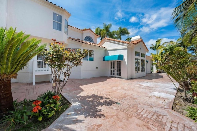 1367 Corona, Bonita, CA 91902 - back of property with french doors, a patio area, stucco siding, and a tiled roof
