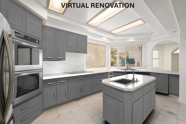 1367 Corona, Bonita, CA 91902 - kitchen featuring gray cabinets, appliances with stainless steel finishes, a raised ceiling, light marble finish floors, and an island with sink