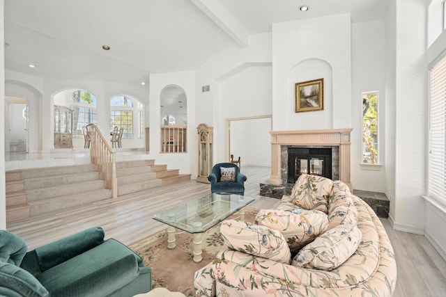 1367 Corona, Bonita, CA 91902 - living area featuring beam ceiling, wood finished floors, a fireplace, arched walkways, and stairs