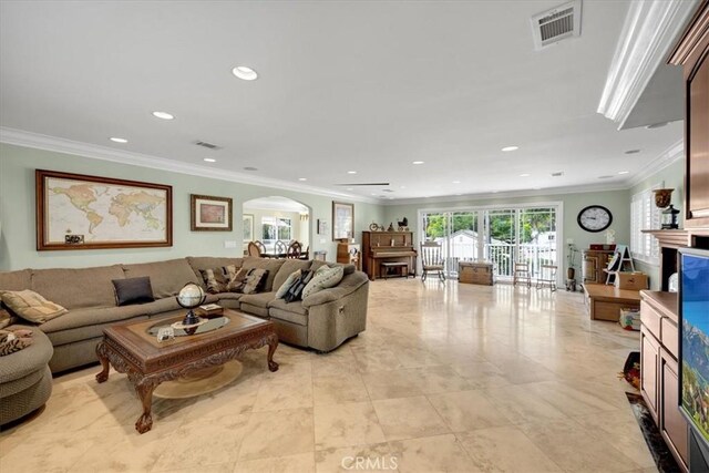 living room with visible vents, arched walkways, recessed lighting, and ornamental molding