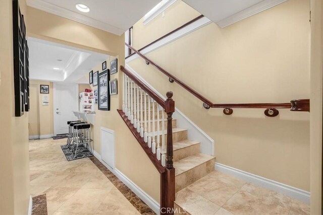 stairway with baseboards, recessed lighting, and crown molding