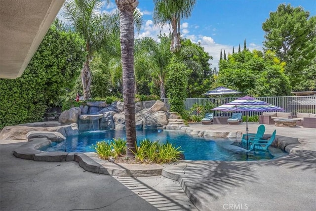 view of pool with a fenced in pool, a fenced backyard, a fire pit, and a patio area