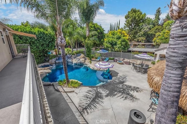 view of swimming pool with a patio, fence, and a fenced in pool