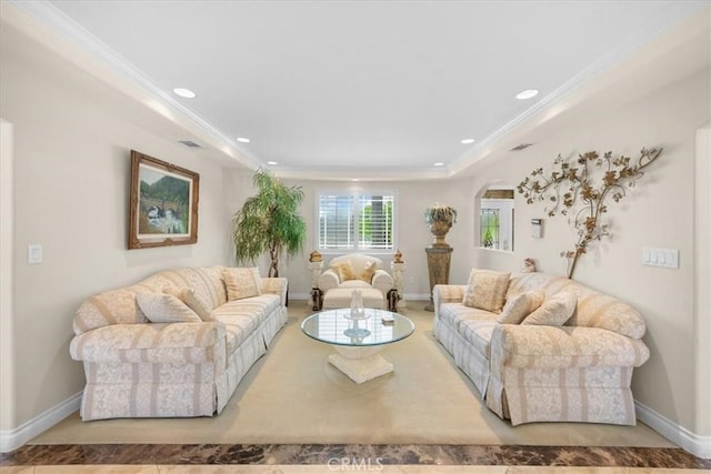 living area with arched walkways, baseboards, recessed lighting, and ornamental molding