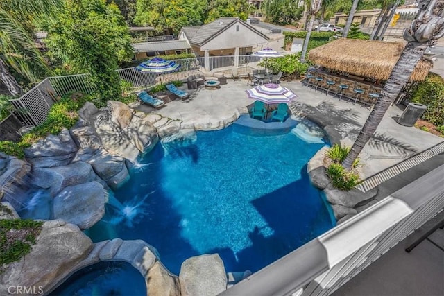 view of swimming pool with a patio, fence, and a fenced in pool