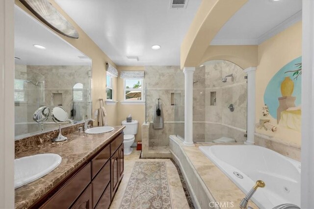 bathroom with a sink, a stall shower, ornate columns, and visible vents