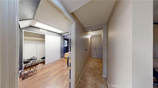 hall featuring wood finished floors and baseboards