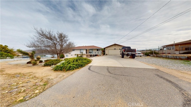 ranch-style home featuring an outbuilding and a detached garage