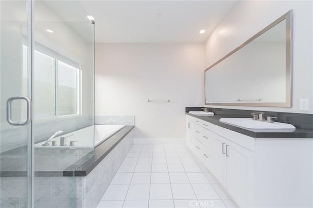 bathroom featuring double vanity, tile patterned floors, a sink, a shower stall, and a bath