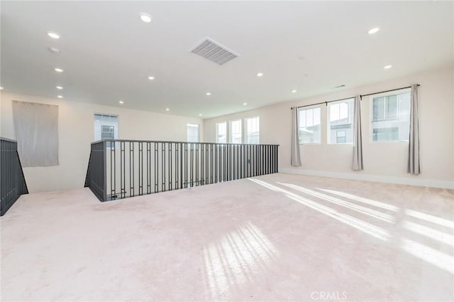 spare room with carpet floors, visible vents, and recessed lighting