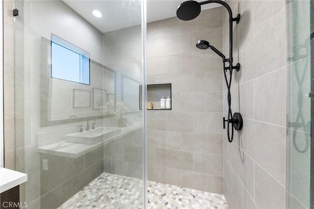 bathroom featuring a stall shower and vanity