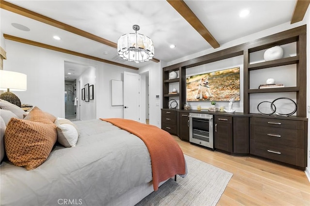 bedroom featuring beam ceiling, a notable chandelier, recessed lighting, light wood-style flooring, and beverage cooler