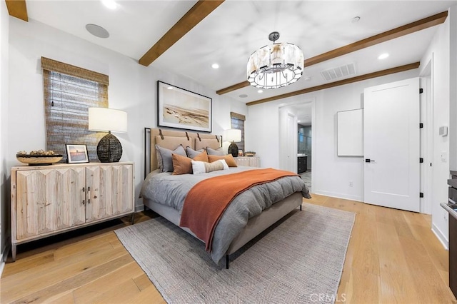 bedroom with a chandelier, connected bathroom, light wood-style flooring, visible vents, and beam ceiling