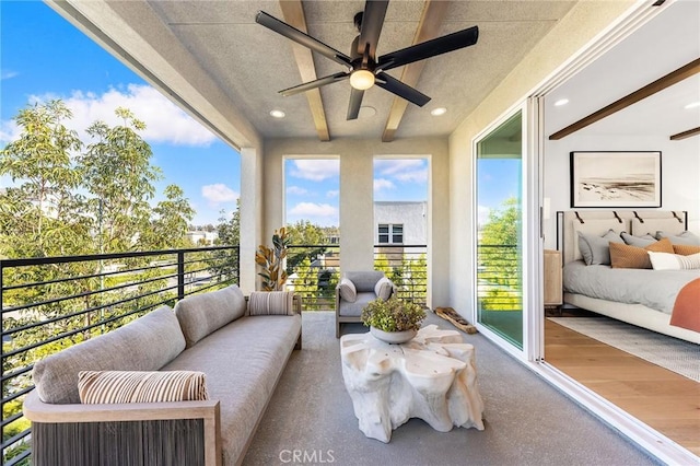 balcony with an outdoor living space and a ceiling fan