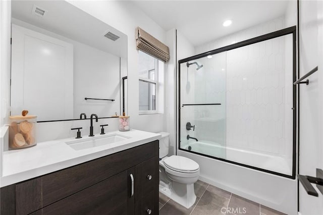 bathroom with toilet, enclosed tub / shower combo, visible vents, and vanity