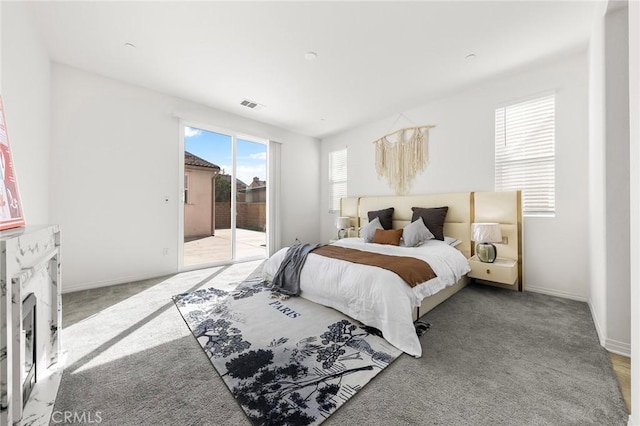 bedroom featuring access to outside, light carpet, visible vents, and baseboards