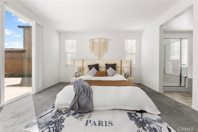 carpeted bedroom featuring ensuite bathroom, access to outside, and baseboards