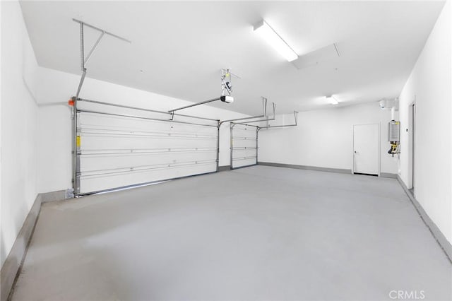 garage featuring water heater, baseboards, and a garage door opener