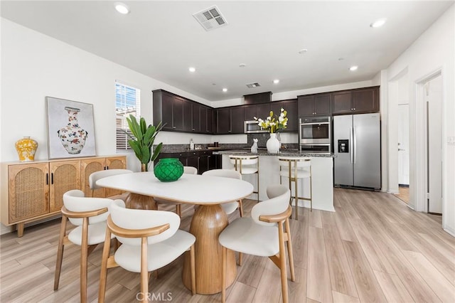 dining space featuring light wood-style flooring, visible vents, and recessed lighting