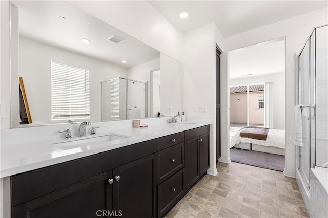 bathroom featuring ensuite bathroom, a sink, visible vents, double vanity, and a stall shower