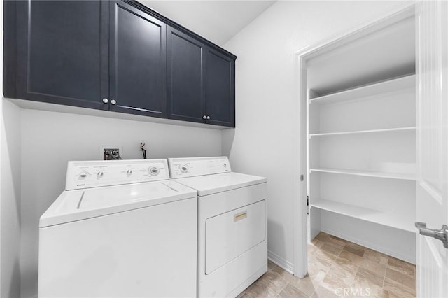 laundry area featuring cabinet space, washing machine and dryer, and baseboards