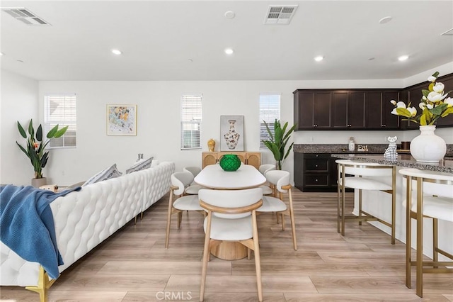 interior space with light wood-type flooring, visible vents, and recessed lighting