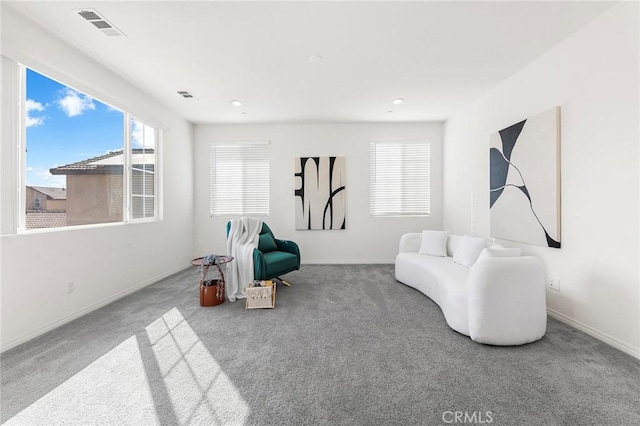 sitting room featuring carpet, visible vents, and baseboards