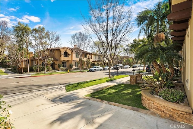 view of community with a residential view and a lawn