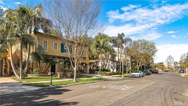 view of road with curbs, sidewalks, and a residential view