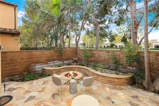 view of patio featuring a fenced backyard and a fire pit