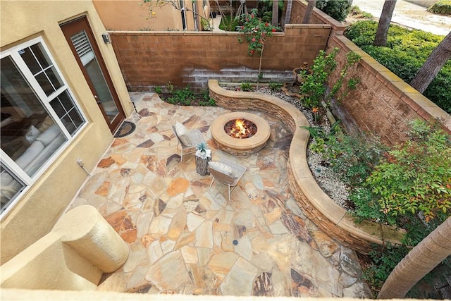 view of patio / terrace featuring a fire pit and fence