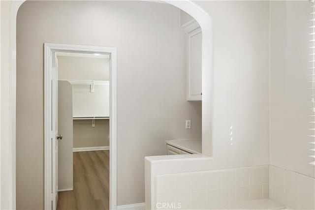 bathroom with baseboards and wood finished floors