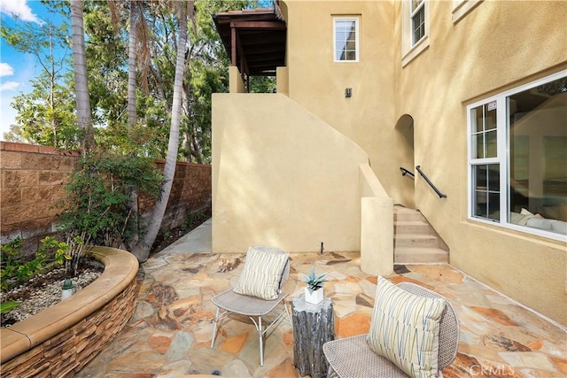 view of patio featuring fence