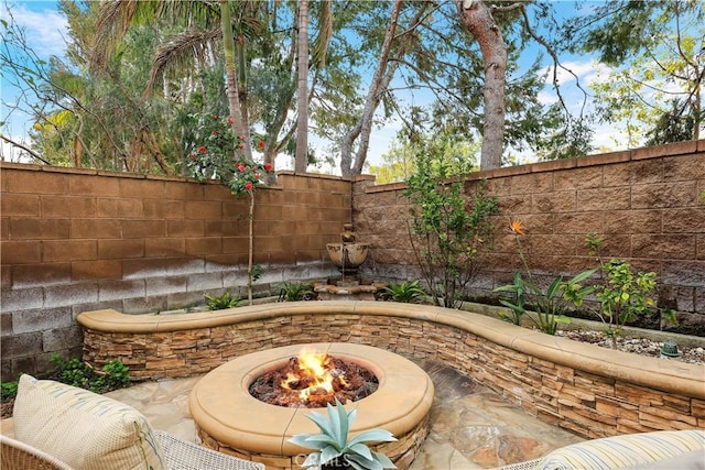 view of patio / terrace featuring a fire pit and a fenced backyard