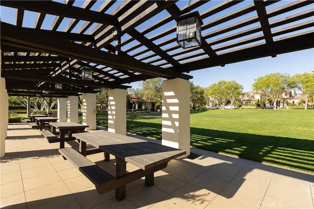 surrounding community featuring a pergola, a lawn, and a patio