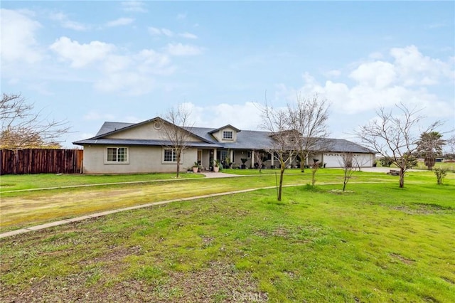 ranch-style home with a garage, a front yard, and fence