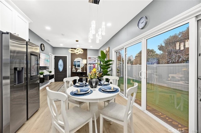 dining area featuring recessed lighting and light wood finished floors