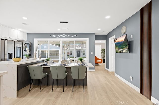 interior space with light wood finished floors, recessed lighting, and baseboards