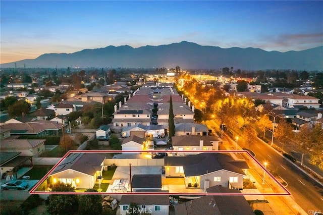 drone / aerial view featuring a residential view and a mountain view