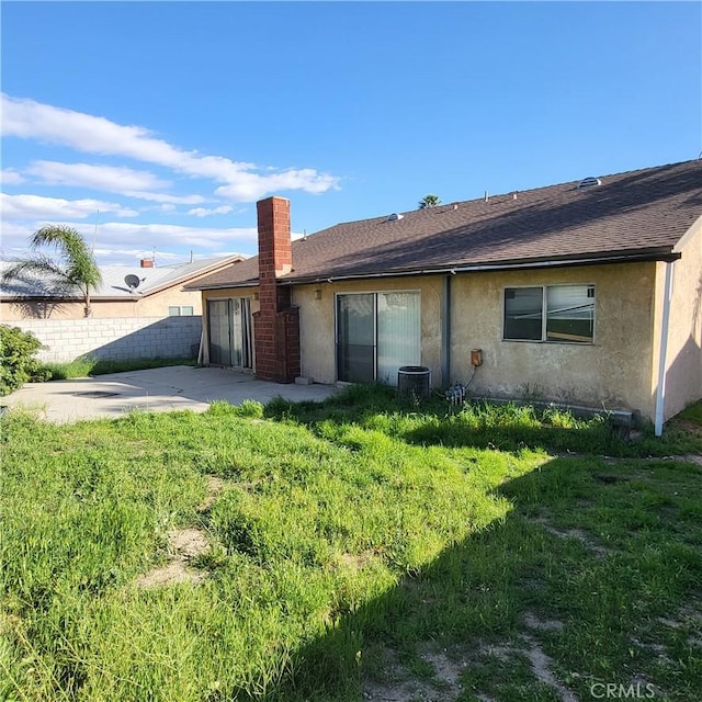 back of house featuring a patio, stucco siding, a shingled roof, central AC, and fence