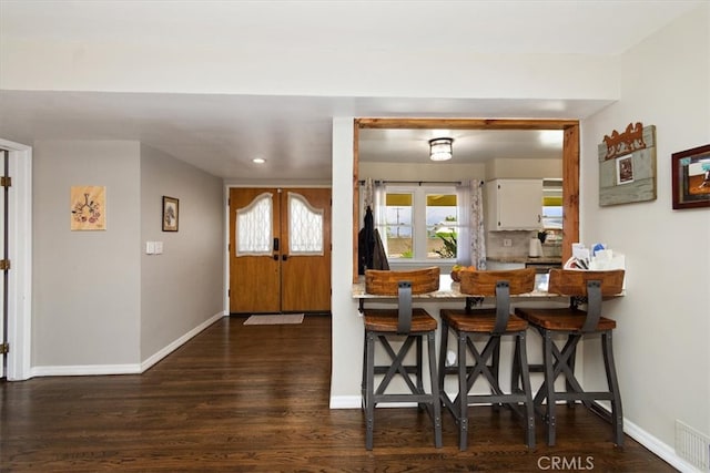 kitchen with french doors, visible vents, baseboards, and white cabinets